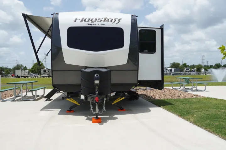 Enjoy a Flagstaff Super Lite RV rental experience! This travel trailer is set up with an awning & slide-out at a scenic campground.. Forest River Flagstaff Super Lite 2021