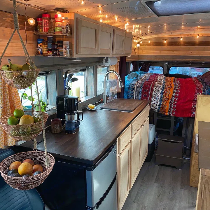 Compact RV rental interior with kitchen, bed, and ambient lighting for comfortable travel.. Ford E450 2005
