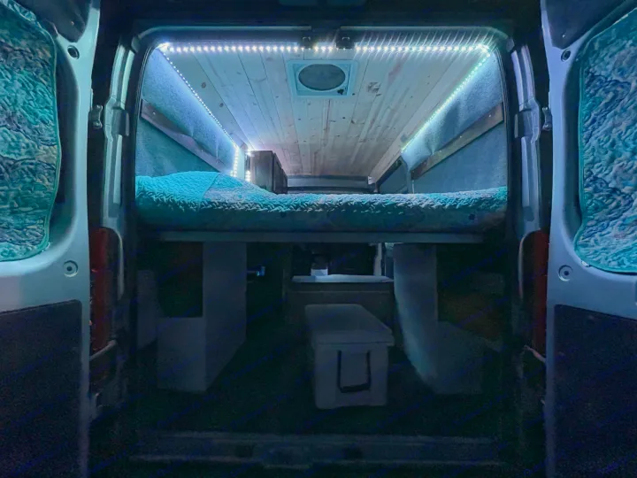 This cozy rv rental van features a comfy bed, wood ceiling, and LED lights, perfect for travel & adventure.. Ram Promaster 2020