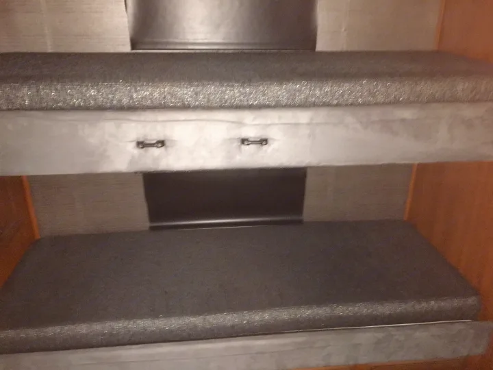 Bunk beds.  Each has a DVD player with a fold down screen and a set of wireless headphones.  
. Fleetwood Discovery 2014