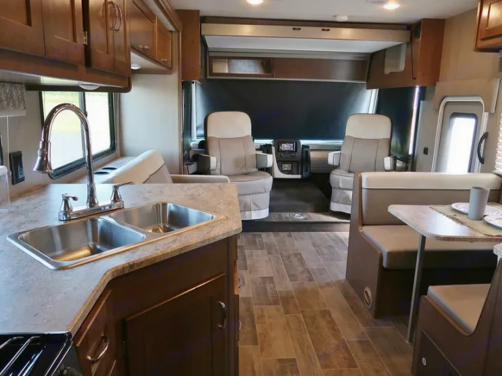 Spacious RV rental interior featuring a full kitchen, dinette, and front cockpit seats. Ideal for travel comfort.. Winnebago Winnebago 2020