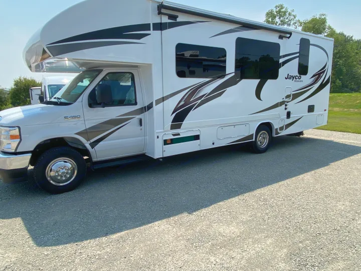 Pristine white Class C RV (Jayco Redhawk) available for rv rental, parked on gravel.. Jayco Redhawk 2025