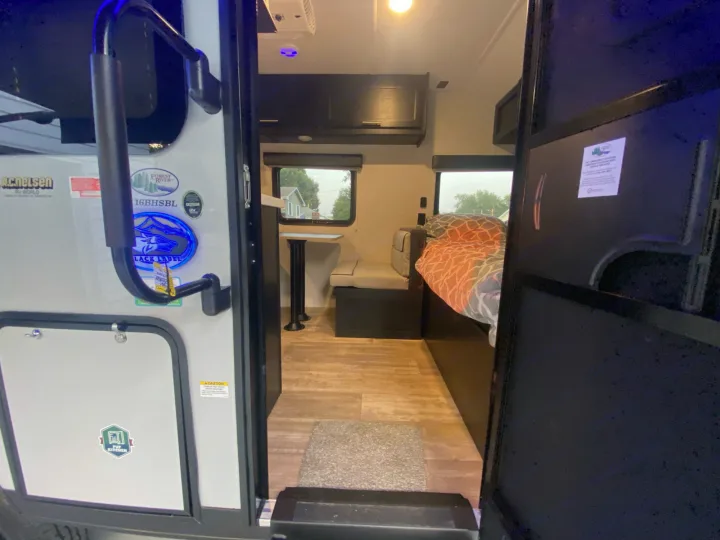 Step inside this RV rental: a glimpse of a Forest River travel trailer with dinette, bed, and exterior FUP Kitchen access.. Forest River Other 2021