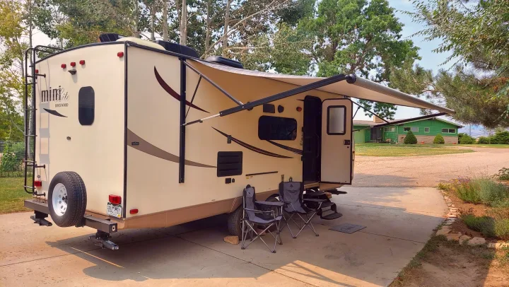 This inviting RV rental is parked with its awning extended and chairs set up, perfect for outdoor relaxation.. Other Other 2016