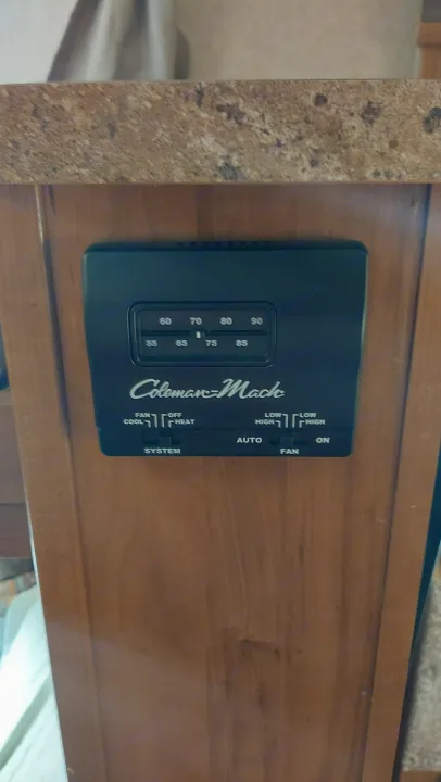 This Coleman-Mack thermostat in an RV rental controls temperature (55-90) and fan settings (cool, heat) for comfort.. Other Other 2016