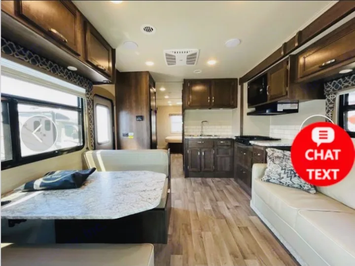 Spacious modern RV rental interior with kitchen, dinette, and living area visible. Enjoy your travels.. Jayco Redhawk 2018