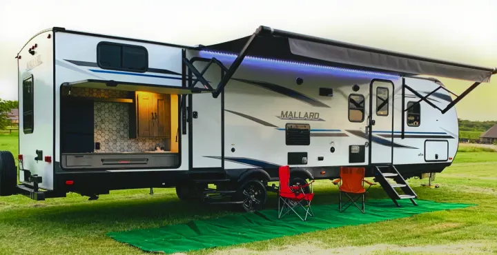 Exterior view with outdoor kitchen (Propane grill included) along with fridge and storage. Heartland Mallard M33 2021
