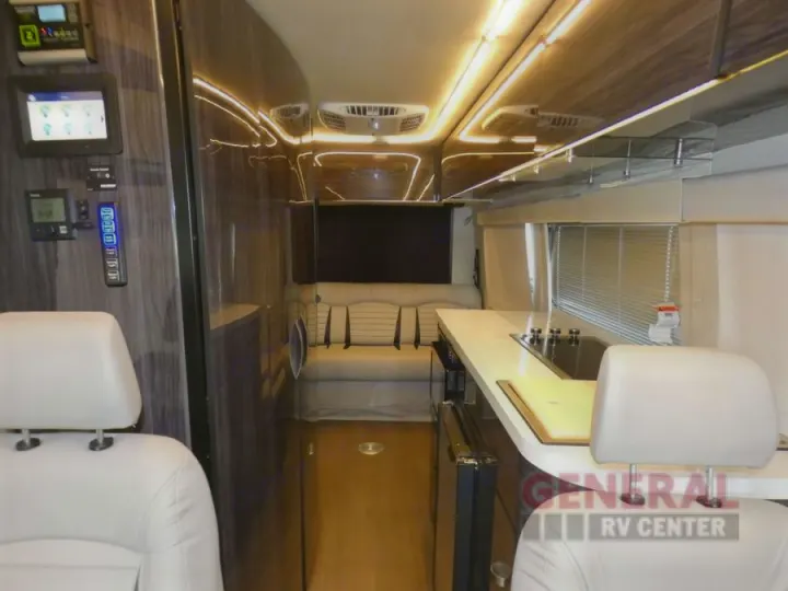 Inside a spacious rv rental with a modern kitchen, comfortable seating, and smart controls.. Winnebago Era 2021