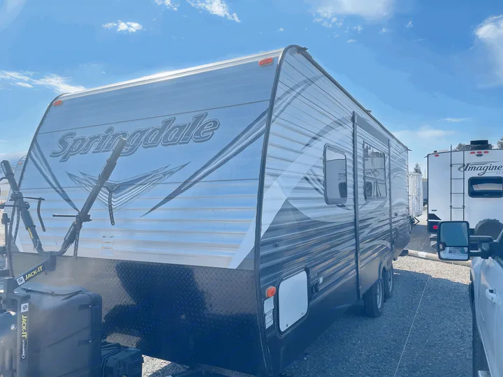 Springdale RV rental with bike rack, ready for camping adventures. Parked under a clear sky.. Keystone Springdale 2017