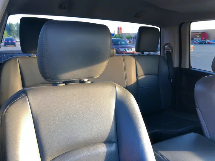 View from a spacious grey truck's rear seats, a suitable RV rental, showing a Target store parking lot with cars.. Dodge 1500 2013