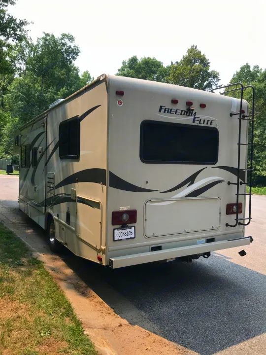 A beige Freedom Elite RV rental, ready for your next road trip or outdoor adventure.. Thor Motor Coach Freedom Elite 2015