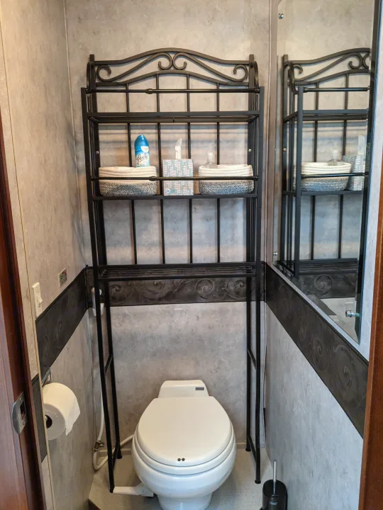 RV rental bathroom featuring a compact toilet and over-the-toilet storage for essentials, maximizing space.. Fleetwood Pace Arrow 2007