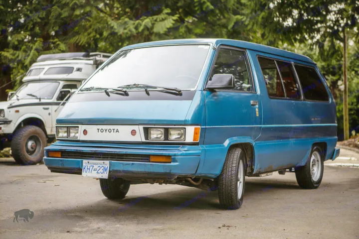 A striking blue Toyota van and white 4x4 camper, parked outdoors. Envision your next RV rental adventure!. Toyota Hiace 1985
