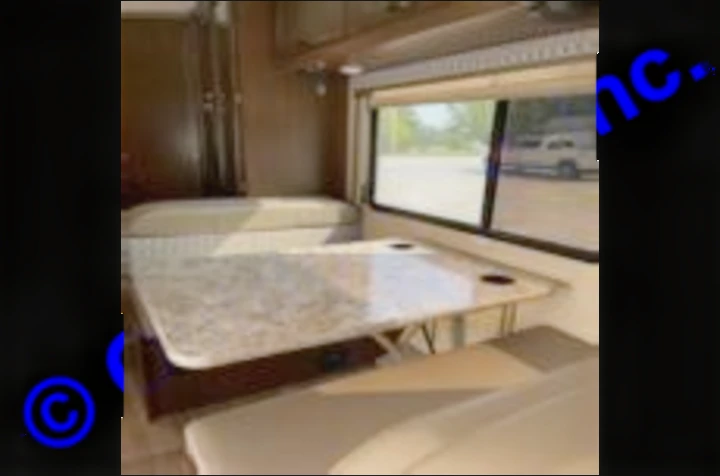 RV rental dinette setup inside a clean motorhome, perfect for meals & relaxation on your next road trip adventure.. Thor Motor Coach Freedom Elite 2019