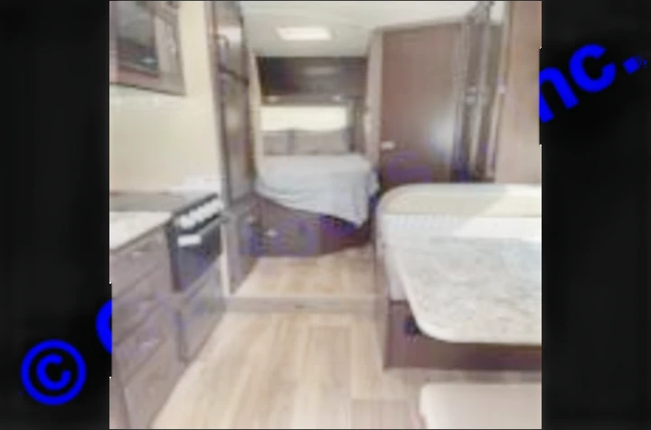 Spacious RV rental interior with kitchen, dining area, and bedroom. Ideal for road trip adventures.. Thor Motor Coach Freedom Elite 2019