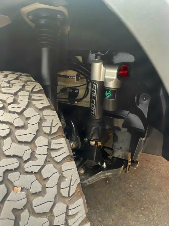Rugged Falcon off-road suspension and aggressive tire on a vehicle, providing durability for any RV rental adventure.. Winnebago Revel 2021