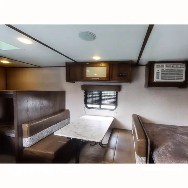 Cozy RV rental interior with dinette, bunk beds, and AC unit, perfect for family adventures.. Other Other 2021