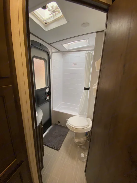 Bathroom with exterior door so that dirt and mud doesn't get tracked through.  Tub and shower combo. Keystone Passport 2021