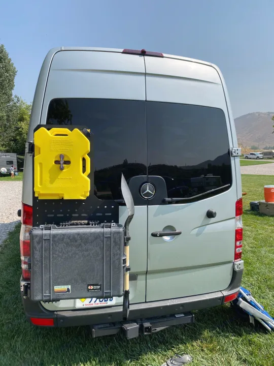 Back of an rv rental Sprinter van with overland gear: Rotopax, Pelican case, shovel on a modular rack for adventures.. Dodge Sprinter 2500 170ext 2008