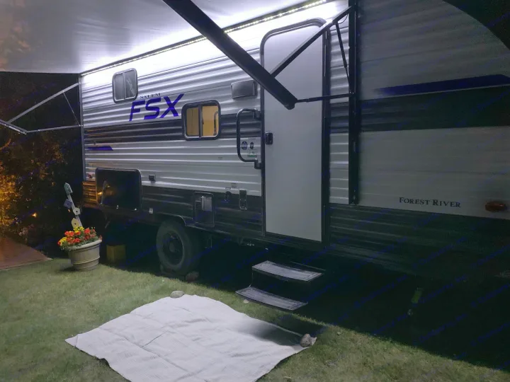 Experience comfortable rv rental camping nights! This travel trailer features illuminated awning, steps, and outdoor mat setup.. Forest River Salem 2021