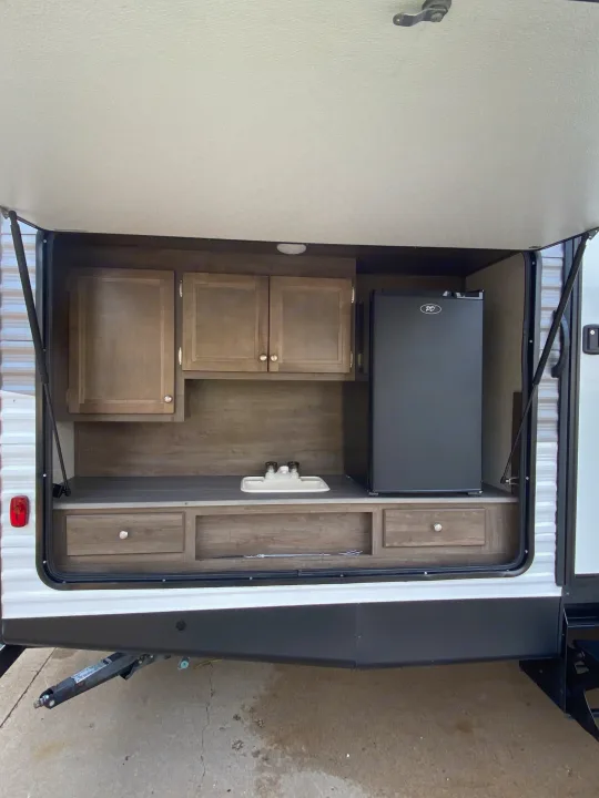 RV rental outdoor kitchen: includes a mini-fridge, sink, cabinets, and drawers. Perfect for camping.. Dutchmen Coleman 2019