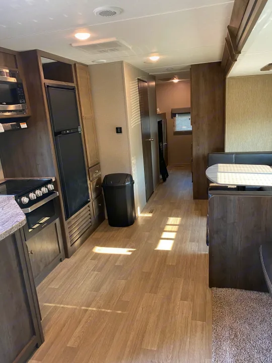 Bright, clean RV rental interior, showcasing a full kitchen, dinette, and ample living space with modern amenities.. Dutchmen Coleman 2019