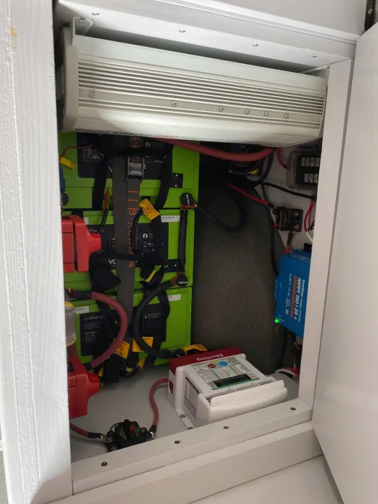 Inside an RV rental cabinet: inverter, lithium batteries, solar charge controller, and power management for off-grid travel.. Dodge Sprinter 2500 170ext 2008