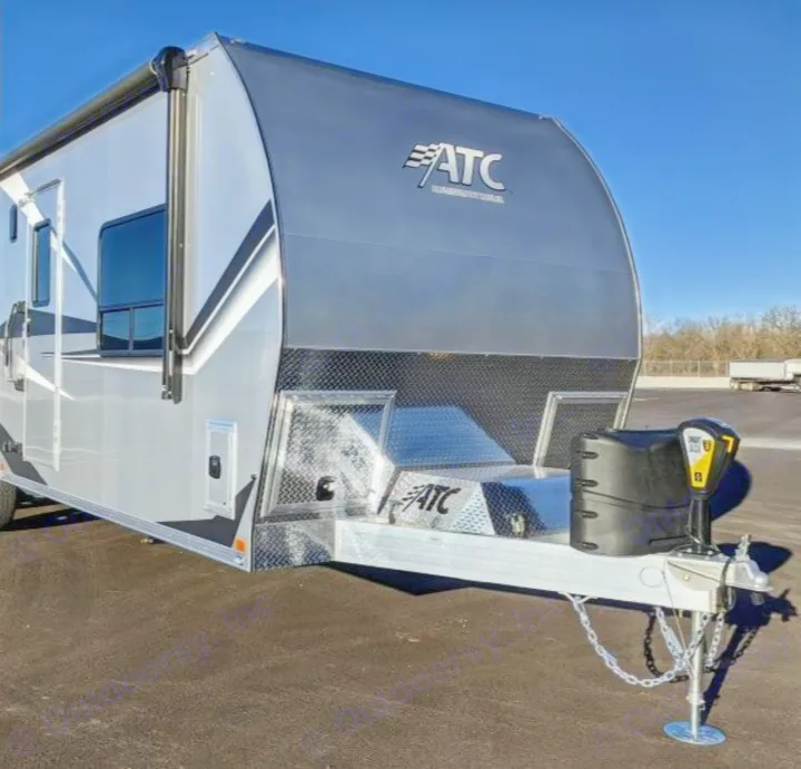 Explore this grey and silver ATC trailer for your next RV rental adventure. A sleek toy hauler with front hitch and awning.. Aluminum Trailer Company 2816 2021