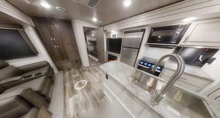 Spacious RV rental interior with modern kitchen, living area, and bunk beds. Perfect for family adventures.. Keystone Cougar Half-Ton 2021