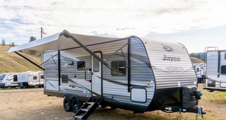 Modern Jayco travel trailer with an extended awning and steps, ready for your next rv rental adventure.. Jayco Jay Flight 2021