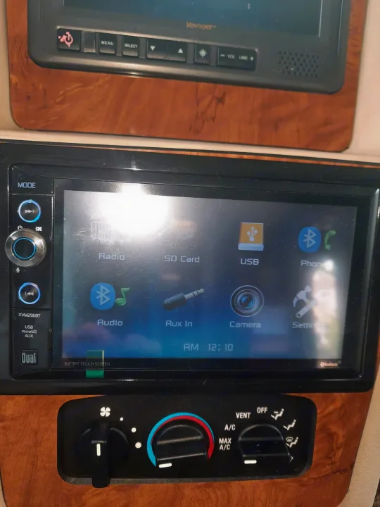 RV rental interior featuring an infotainment system, climate controls, and an overhead entertainment display.. Ford Coachman 2009