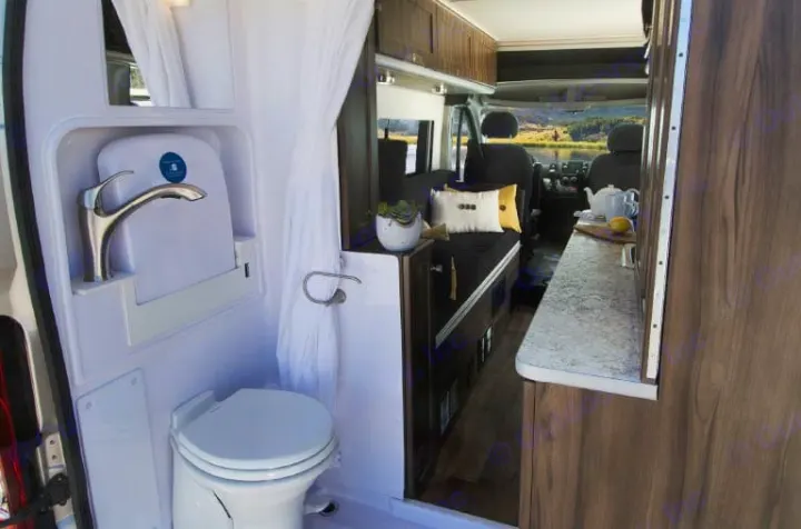 Explore the comfort of an RV rental: compact bathroom with shower, cozy living space, and kitchen counter with a view.. Hymer Axion Other 2019