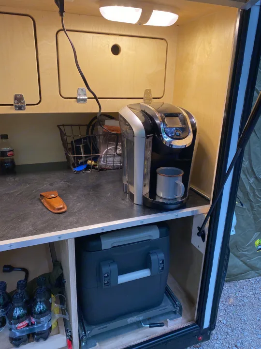 Practical RV rental kitchenette: Keurig coffee maker, portable fridge on a pull-out, and organized wood cabinets.. Other Other 2021