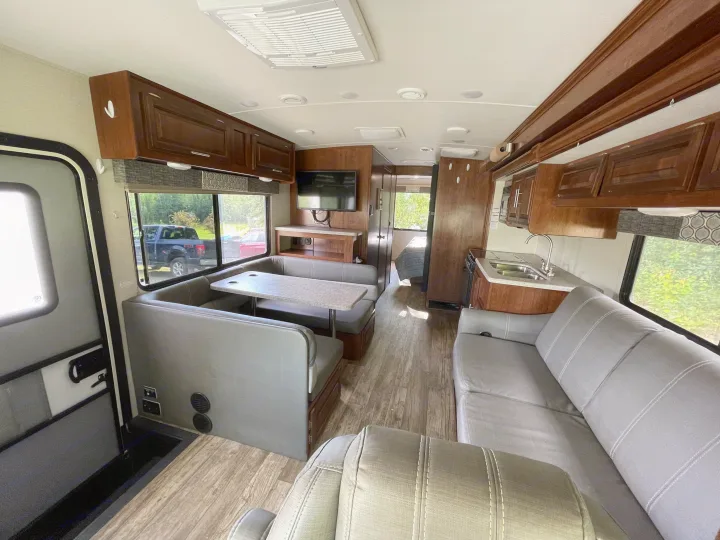 Spacious rv rental interior featuring a dinette, kitchen, living area, and wood flooring. Perfect for your next adventure.. Forest River Forester 2018