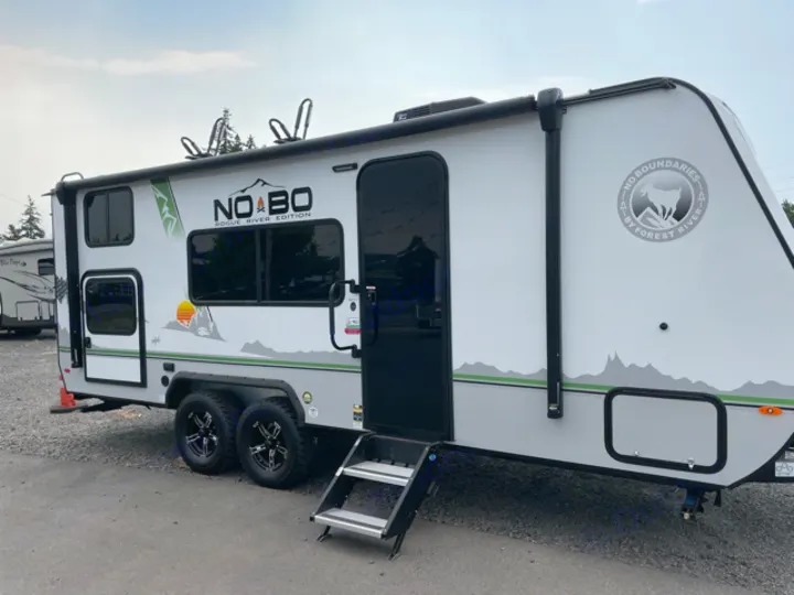 Modern gray and white Forest River No Boundaries travel trailer, ideal for your next RV rental and outdoor camping adventure.. Forest River No Boundaries 2021