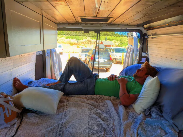 Relaxing inside a cozy RV rental, enjoying the view from a converted van.. Dodge Promaster 2500 High Roof 2020