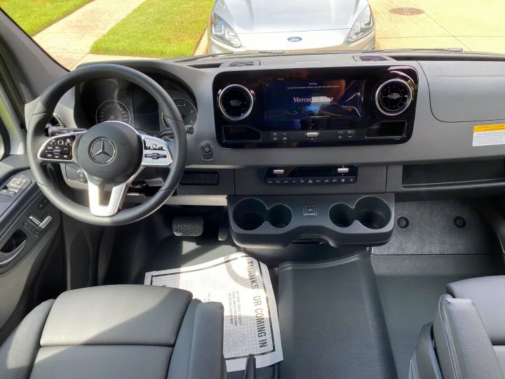 New rv rental! View of a Mercedes-Benz Sprinter van interior, with dashboard, steering wheel, and modern infotainment.. Mercedes-Benz Sprinter 2021