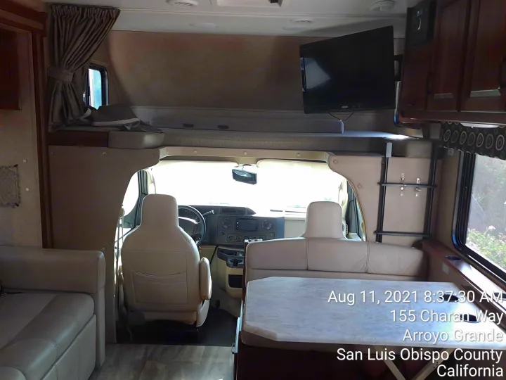 Spacious RV rental interior featuring a large overhead bunk bed, comfortable dinette, and a well-equipped driver's cabin.. Forest River Sunseeker 2018