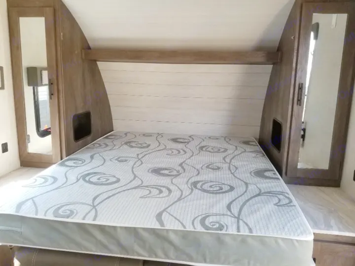 RV rental bedroom: a compact space featuring a patterned mattress, built-in storage, and mirrored cabinets.. Forest River Salem Cruise Lite 2021