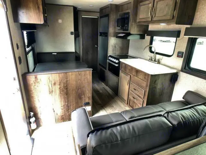Clean RV rental interior: kitchen, dinette, and sofa lounge. Your comfortable home on wheels awaits your next adventure.. Jayco Flight 2021
