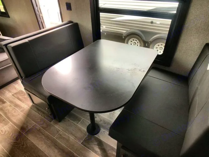 RV rental interior: cozy dinette with black benches & table. Perfect for dining & relaxing on the road.. Jayco Flight 2021