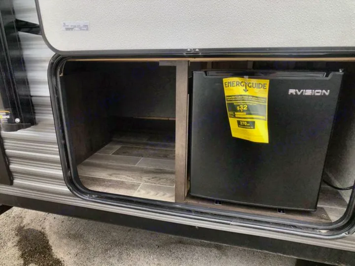 RV rental with convenient exterior mini-fridge and storage compartment, perfect for outdoor living.. Jayco Flight 2021