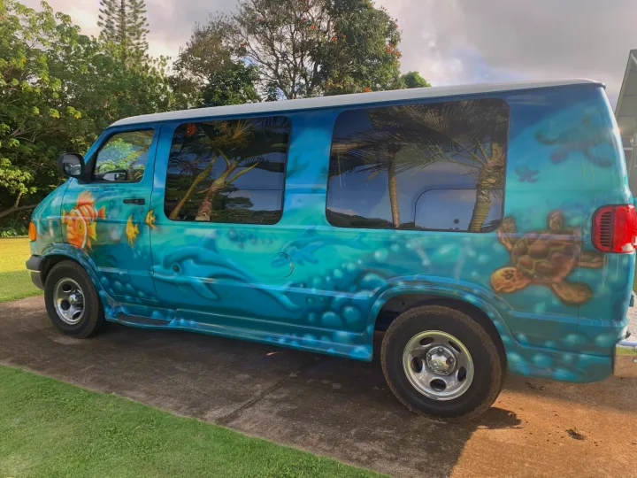 Explore with this vibrant ocean-themed van, an RV rental featuring clownfish, sea turtles, and flowing blue waters.. Dodge Ram 1500 1999