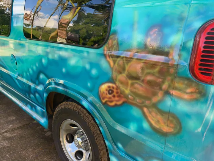 Unique turquoise RV rental features a vivid custom airbrush mural: a sea turtle in an ocean scene.. Dodge Ram 1500 1999