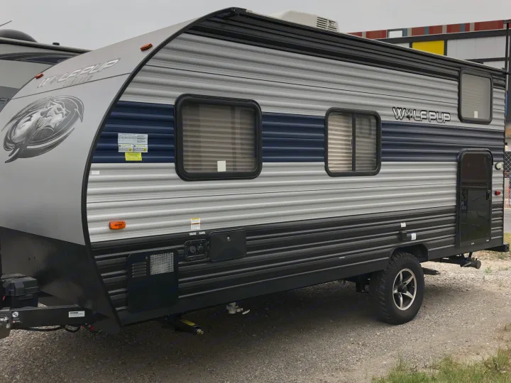 Wolf Pup travel trailer, grey/blue striped exterior. Perfect for an RV rental or camping trip.. Forest River Wolf Pup 2021