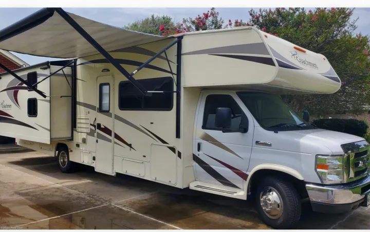 White and tan Class C motorhome RV rental, featuring an extended awning and slide-out. Perfect for your next adventure.. Coachmen Freelander 31BH 2017