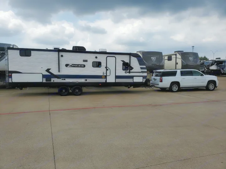 Side view of the Royal Haul being towed away to our first camp site!. Crossroads Zinger 2021