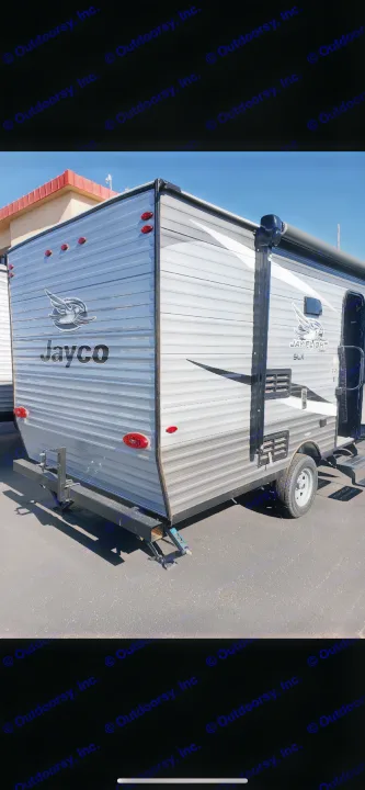 Rear and side view of a grey Jayco Jay Flight SLX travel trailer, a compact RV perfect for rv rental.. Jayco Jay Flight 2021