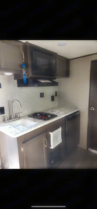 This RV rental offers a compact kitchenette with microwave, stovetop, sink, and small fridge, great for adventures.. Jayco Jay Flight 2021