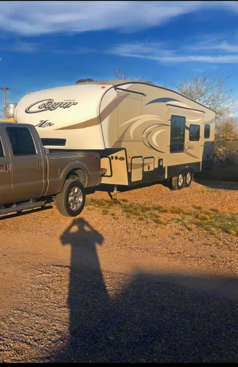 This RV rental features a Cougar fifth-wheel and pickup truck, ideal for camping and travel adventures.. Keystone Cougar 2017